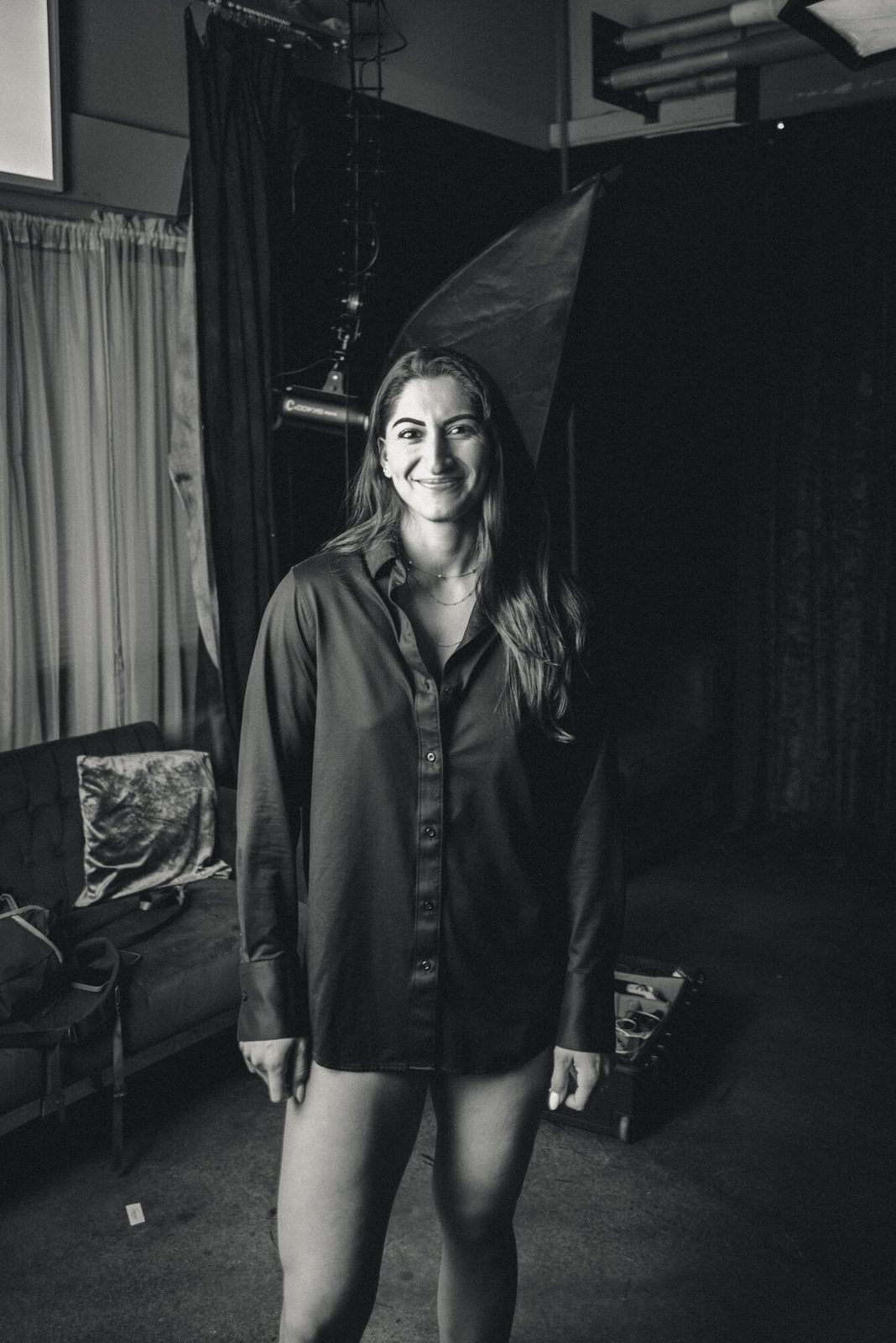 Candid black and white in an oversized shirt, easy smile
