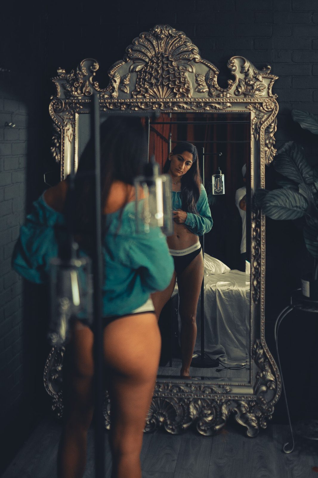Reflected in an ornate gilt mirror, layered and moody